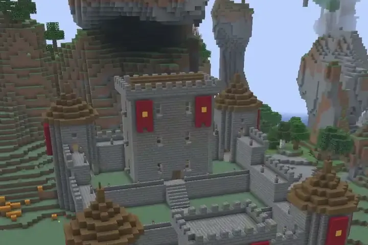 A stone castle with red banners being built in a Minecraft world.